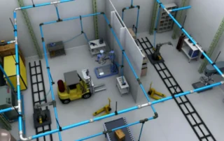 Sistema de tubulações de ar comprimido industrial distribuindo ar para máquinas e equipamentos em uma fábrica.